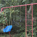 Red metal playground swing set with multiple swings and gym rings - thumbnail 5 of 5
