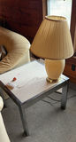Beige ceramic table lamp with pleated shade on marble-top end table - thumbnail 1 of 5
