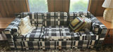 Plaid sleeper sofa with cushions and floral sheet - thumbnail 1 of 5