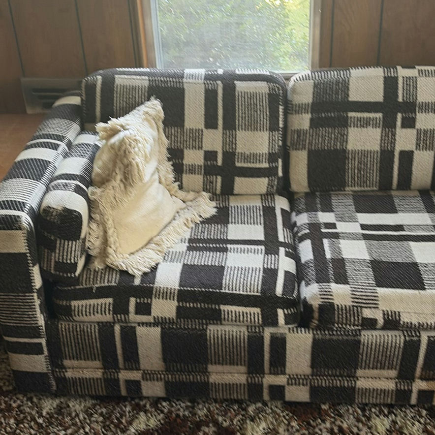Plaid sleeper sofa with cushions and floral sheet - image 2 of 5