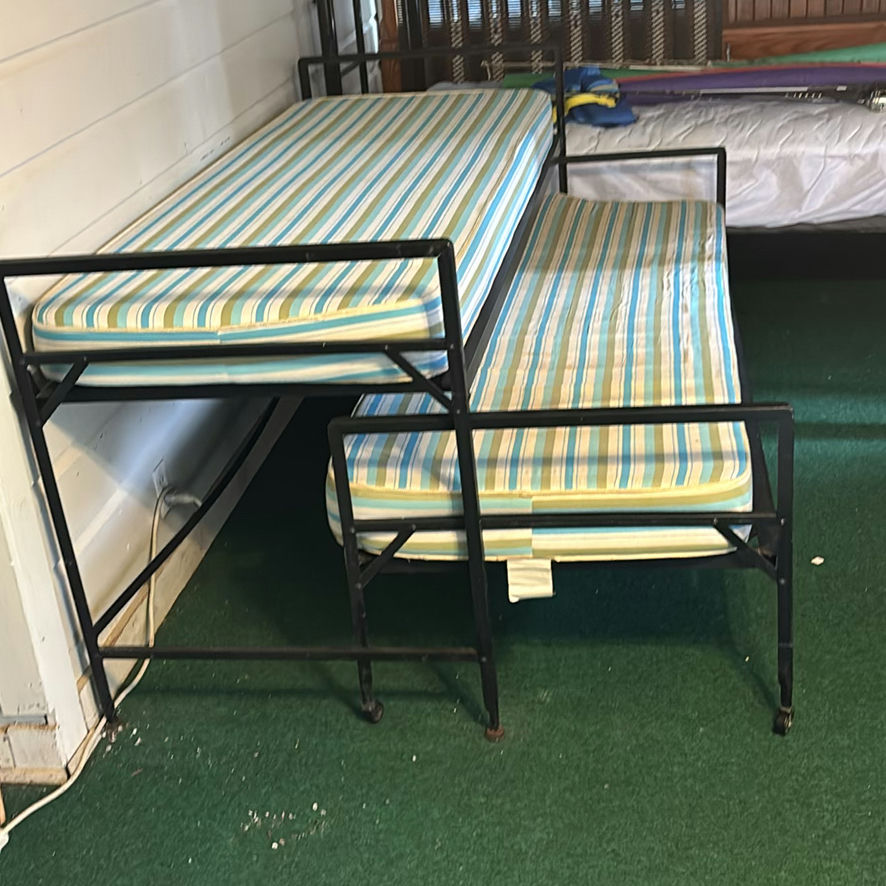 Metal bunk bed frames with striped twin mattresses - image 1 of 3