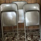 Stacked metal folding chairs - thumbnail 2 of 6