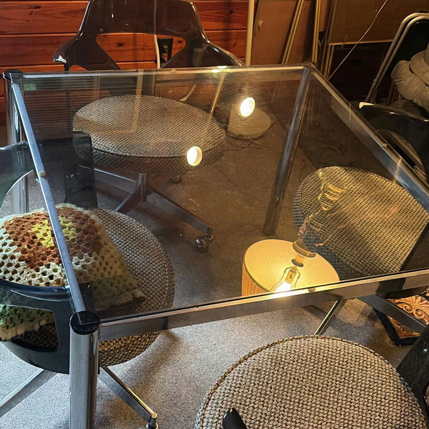 Glass-top dining table with four chrome-and-black swivel chairs - image 2 of 8