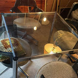 Glass-top dining table with four chrome-and-black swivel chairs - thumbnail 2 of 8