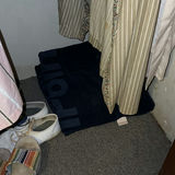Closet with hanging clothes and footwear - thumbnail 3 of 4