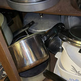 Assorted cookware and enamelware in a cabinet - thumbnail 7 of 10