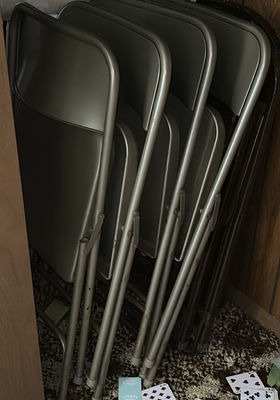 Stacked metal folding chairs - Image 1 of 6