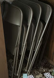 Stacked metal folding chairs - thumbnail 1 of 6