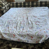 Plaid sleeper sofa with cushions and floral sheet - thumbnail 4 of 5