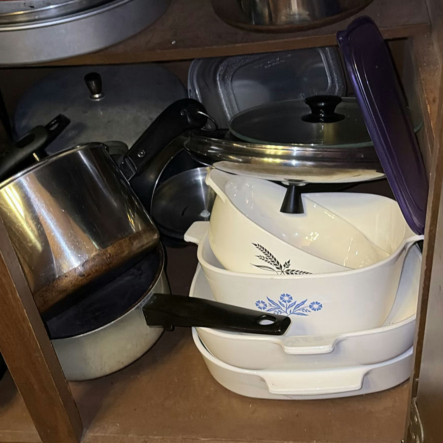 Assorted cookware and enamelware in a cabinet - image 6 of 10