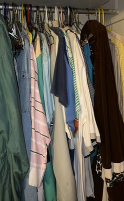 Closet with hanging clothes and footwear - Image 1 of 4