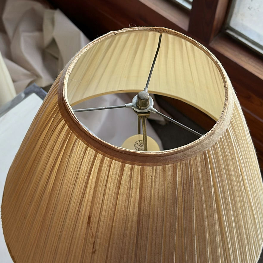 Beige ceramic table lamp with pleated shade on marble-top end table - image 5 of 5