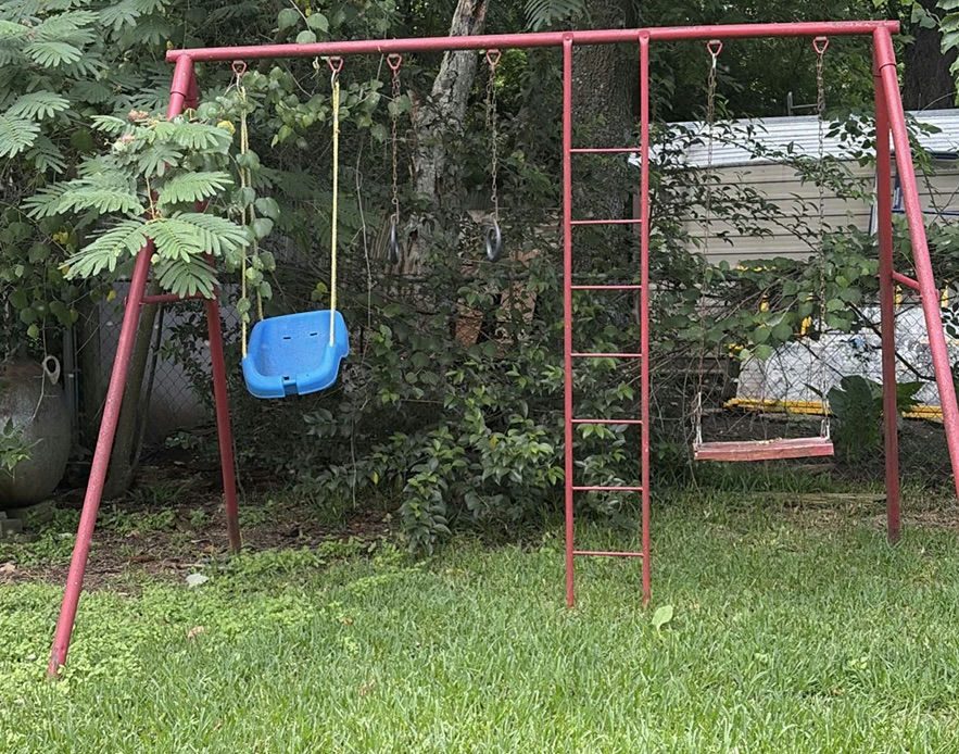 Red metal playground swing set with multiple swings and gym rings - image 2 of 5